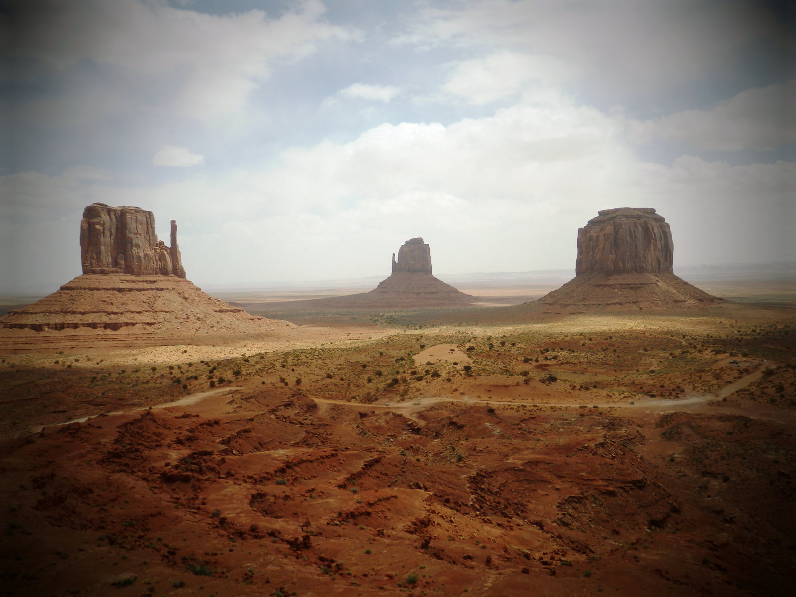The Mittens and Merrick Butte across the Monument Valley desert landscape