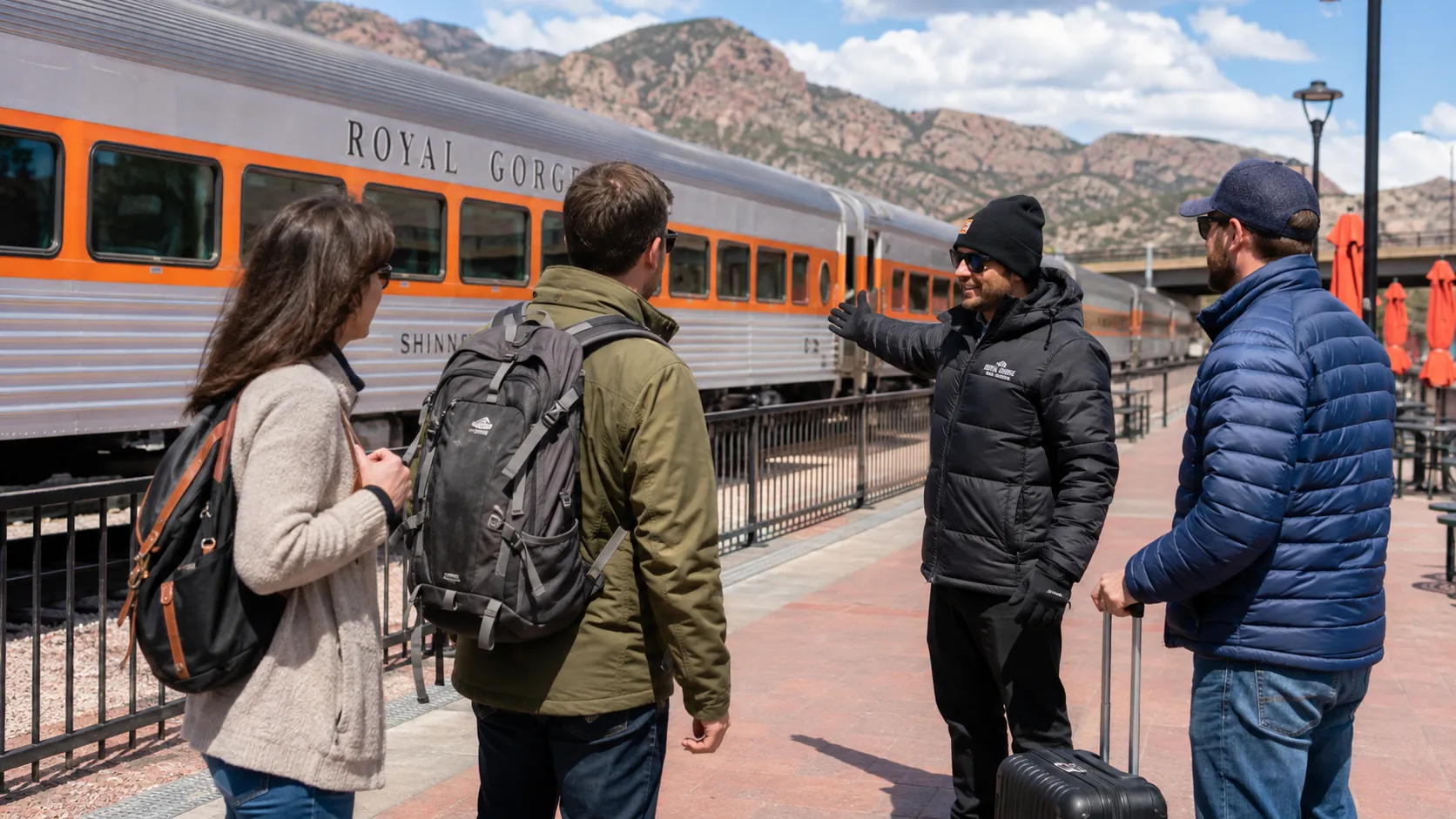 Host assisting guests with boarding and passenger coordination on the Royal Gorge Route Railroad platform in Colorado